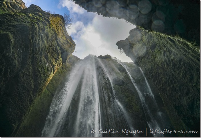 Looking up at Gljúfrabúi waterfall surrounded by cliffs