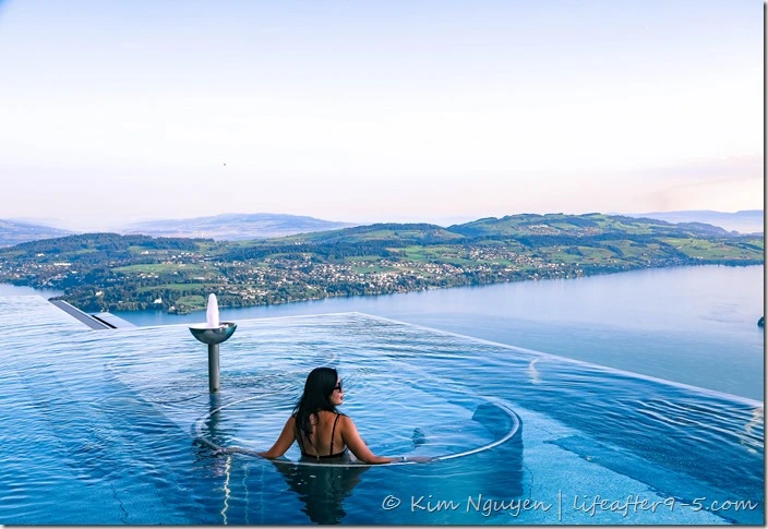 Woman admiring view from outdoor pool at Bürgenstock Alpine Spa